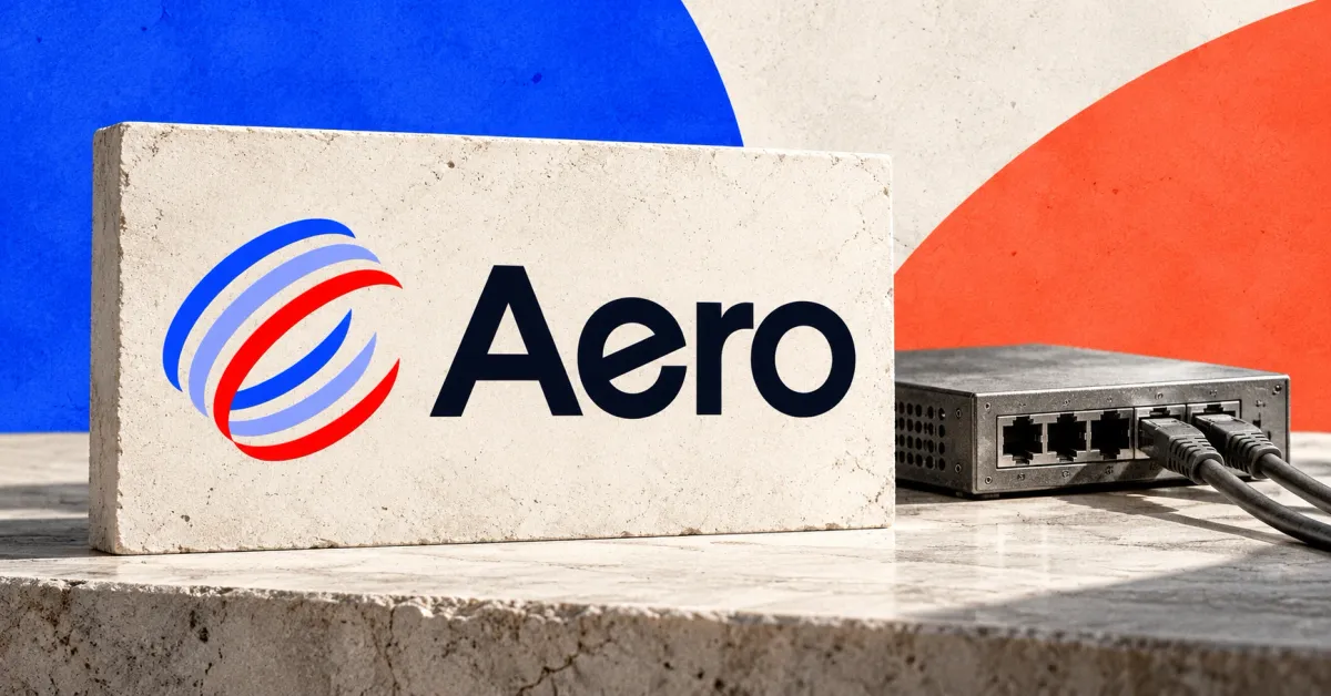 One large official Aero logo with its blue, lavender and red pinwheel and dark wordmark on an ivory stone sign beside a smaller unbranded greyscale network switch with two connected cables, against cobalt and coral panels.