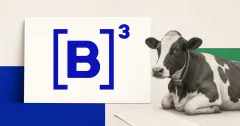 Large official B3 blue logo on a white placard beside a greyscale dairy cow wearing an unbranded smart collar and a blank agricultural credit document.