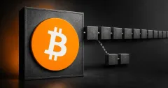 Large official orange Bitcoin logo on a charcoal plaque beside a greyscale unbranded split-chain ledger, with a long continuing row of blocks and a short stalled branch.