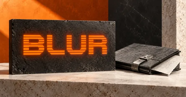 One large official orange striped BLUR wordmark on a charcoal stone sign beside an unbranded greyscale archival art folio with a metal clasp and blank textured sheet, against orange, charcoal and off-white architectural panels.