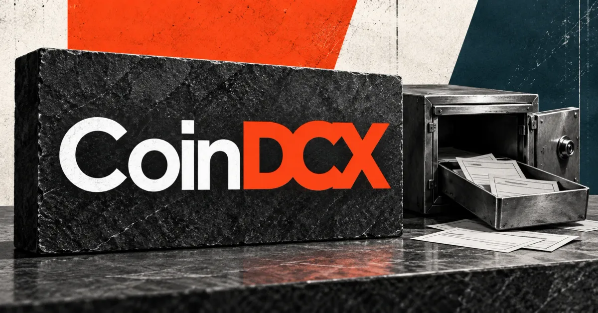 One large official CoinDCX wordmark, with white Coin and orange DCX lettering on a frontal charcoal stone sign, beside a smaller unbranded greyscale metal deposit box with an inspection tray and blank slips, against off-white, orange and petrol panels.