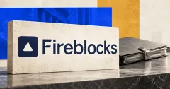 One large official navy Fireblocks icon and wordmark on an ivory stone sign beside a smaller unbranded greyscale closed transaction folder with a metal clasp, against off-white, cobalt and ochre editorial panels.