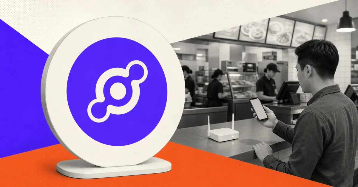 Official purple Helium chain-link mark on a large cream sign beside a greyscale fast-food counter, customer with a smartphone and Wi-Fi hotspot, representing carrier data offload.