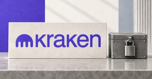 Large official purple Kraken emblem and wordmark on an off-white desk sign beside an unbranded greyscale locked metal collateral box.