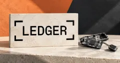 One prominent official black LEDGER wordmark with four corner brackets on an off-white stone sign beside an unbranded greyscale exposed hardware-wallet circuit board and wired module, against apricot and charcoal panels; conceptual illustration, not a forensic photograph.