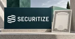 Large official white Securitize ribbon emblem and SECURITIZE wordmark on a dark teal sign beside an unbranded greyscale share certificate, against off-white stone architecture and mint-green panels.