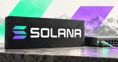 One large official Solana gradient emblem and white SOLANA wordmark on a charcoal stone sign beside a smaller unbranded greyscale network switch with a connected cable, against mint and violet panels and mountain imagery.